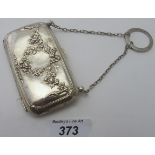 A silver rectangular purse, embossed both sides with swags, bows and flowers, lined with green felt,