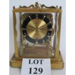 A Schatz striking and chiming mantel clock in glazed brass case with choice of chimes.