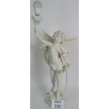 A Spelter figural lamp in the form of Cupid holding a torch.