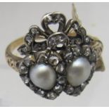 An antique ring in the Georgian style, possibly gold and platinum set with two Mabe pearls,