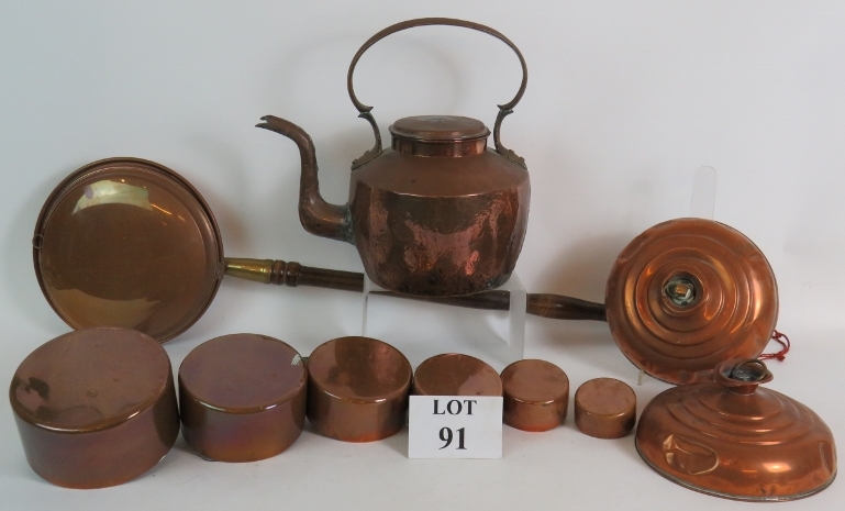 A quantity of copper items including a large heavy duty antique kettle, two bed warming flasks,