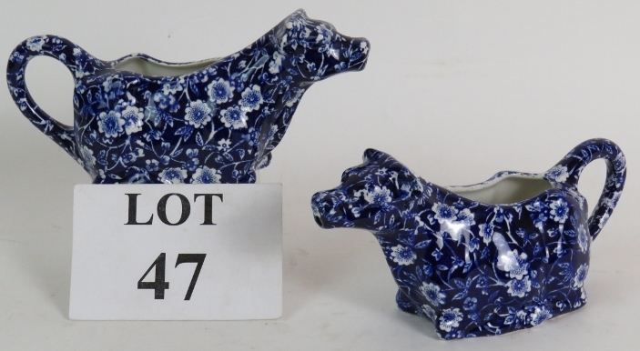 A pair of blue + white Burleigh Staffordshire calico cow creamers. Condition report: No issues.