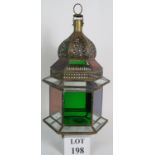 An Eastern style brass and glass lantern with coloured glass panels. Overall height: 52cm.