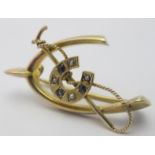 A 9ct gold brooch in the form of a wishbone, (one side slightly smaller),