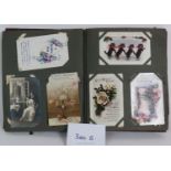 An early 20th Century postcard album containing a wide selection of postcards and greetings cards