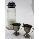 A glass engraved sifter with silver lid, Sheffield 1931 and two small silver engraved trophy cups,