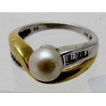 A 14ct white and gold ring set with centre pearl and five baguette cut diamond shoulders either
