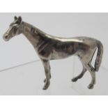A small figure of a standing horse, marked 800, approx 2" x 1 1/2", good condition.