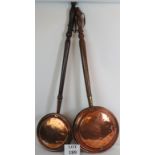 Two 19th Century heavy gauge copper bed warming pans with turned hardwood handles. Length: 108cm.