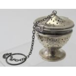 A tea infuser on a pedestal base, with hinged lid, marked sterling.