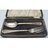 A heavily engraved Victorian silver christening spoon and fork, London 1883, makers GMJ,