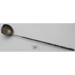 A Georgian toddy ladle, with whale bone handle, small dent and tear on the edge,