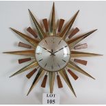 A 1960's vintage Metamec Sunburst wall clock in gold metal and teak.