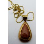 A Goldstone pendant, (some wear), on an 18ct gold fine box chain, approx weight of chain 5.3 grams.