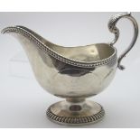 A heavy silver Georgian sauce boat on pedestal base,