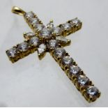A 14ct yellow gold cross set with white stones.