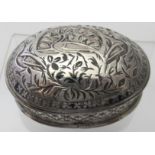 An antique small oval white metal box,