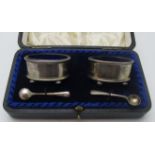 A pair of oval salts on ball feet, and with blue liners, London 1915,