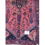 A good Hamadan rug on red ground. 2.10 x 1.00 Condition report: In excellent condition.