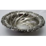 A good quality silver dish, scrolls embossed with flowers and foliage, London 1890, William Comyns,