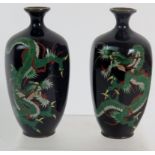 A pair of high quality Meiji period Cloisonne vases depicting dragons on a dark blue ground.