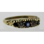 An 18ct gold ring set with three sapphires and two diamonds, size N.