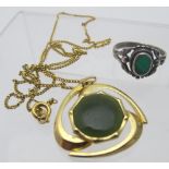 A Nephrite jade pendant on a yellow metal chain, New Zealand, boxed,