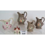 A set of three antique grey glazed Staffordshire pottery jugs with swan neck handles and applied