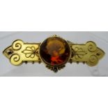 A 15ct yellow gold bar brooch in the Etruscan style and inset with orange stone, total weight 11.