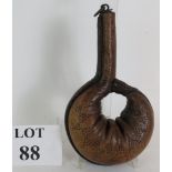 An antique bladder shaped leather powder flask, possibly Spanish,