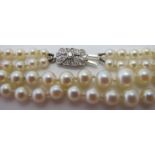 A two strand cultured pearl graduated necklace with diamond clasp, set with fifteen diamonds,