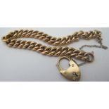 A curb link bracelet and heart shaped padlock, stamped 15ct, on a white metal safety chain,
