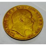 An Edwardian 1/2 sovereign 1906, approx 4 grams, in an old leather ring case. Condition worn.