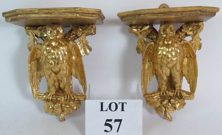 A pair of carved hardwood gilt owl in oak tree wall brackets or shelves.