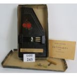 A vintage German auto harp Zither with original box, turning key, instruction book and finger picks.