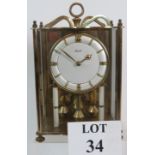 A Prescott 400 Day anniversary clock, brass glazed case. Height is 26cm.