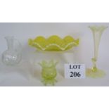 Three pieces of antique uranium vaseline glass including an Epergne vase and similar clear vaseline
