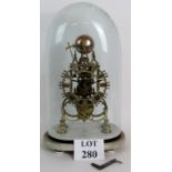 A Victorian brass striking skeleton clock mounted on a white marble base and under a period glass