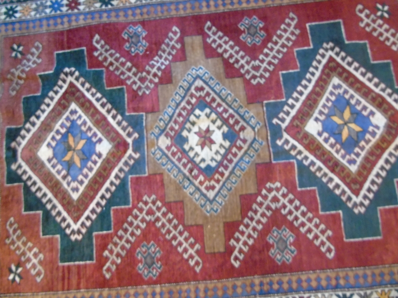 A Caucasion rug with three diamond motifs to center surrounded by a four layer border. - Image 3 of 3