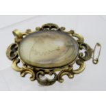 An early Victorian yellow metal mourning brooch, probably pinchbeck,