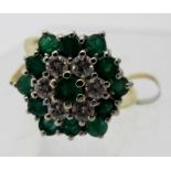 An 18ct gold diamond and emerald cluster ring, diamonds approx 0.6cts, and emeralds 1.15cts, size M.