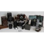A collection of vintage cameras and accessories including a Voigtlander Bessa, Kodak No 2 Hawkette,