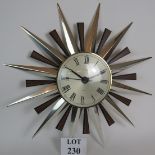 A vintage Metamec starburst wall clock with quartz movement. Max diameter 60cm.