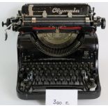 A vintage Olympia model 8 typewriter, made in Germany, with green canvas cover.