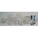 A large collection of mainly cut glass items including jugs, cruets, vases, dessert bowls etc.