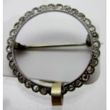 A stylish diamond set white metal circular brooch, believed to be 18ct white gold,