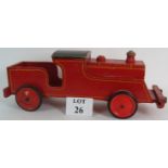 A large vintage wooden triang 'Loco' pull along train toy, red with yellow striping.