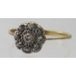 An 18ct gold small diamond cluster ring, comprising of nine diamonds, size M.