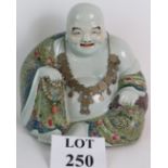 A Chinese porcelain figure of 10th Century Buddhist monk Pu-Tai.