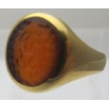 An 18ct gold signet ring set with citrine and engraved with family crest, size L, approx 5.9 grams.